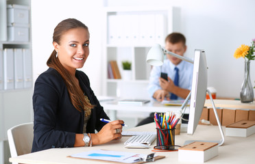 Fashion designers working in studio sitting on the desk