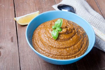 Turkish traditional meal - lentil soup Mercimek corbası on a wo