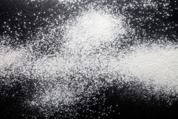 Flour spilling on monophonic background. Selective focus