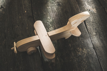 Vintage wooden plane on wooden board