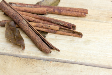 cinnamon and herb sticks on  wooden table