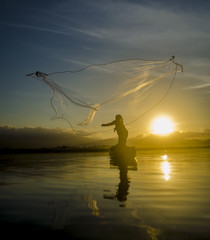 Fisherman of Bangpra Lake in action when fishing, Thailand.