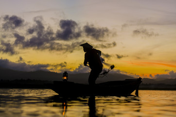 Fototapeta na wymiar Fisherman of Bangpra Lake in action when fishing, Thailand