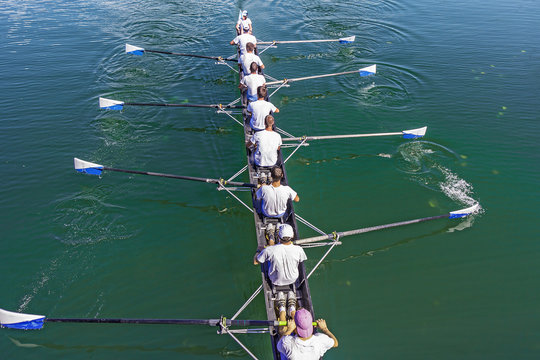 Boat coxed eight Rowers training rowing on the lake