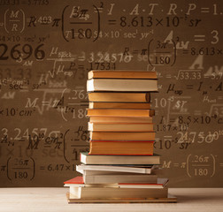 Books on vintage background with math formulas