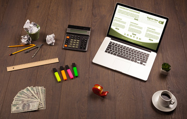 Business table with notebook computer and office accessories