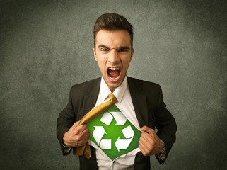 Enviromentalist business man tearing off shirt with recycle sign