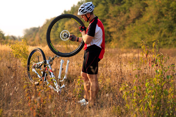 Bike repair. Young man repairing mountain bike