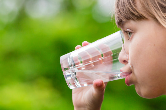 Child drinking glass of fresh water
