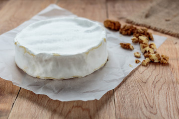 Camembert on old rustic wooden table