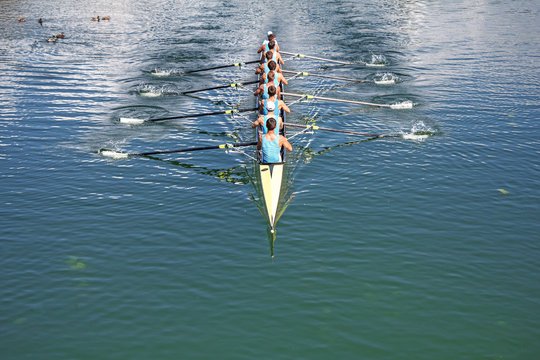 Boat coxed eight Rowers training rowing on the lake