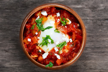 Fresh Eggs poached in tomato sauce and red, yellow pepper, onion