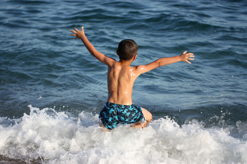 Fototapeta premium happy boy running in the sea