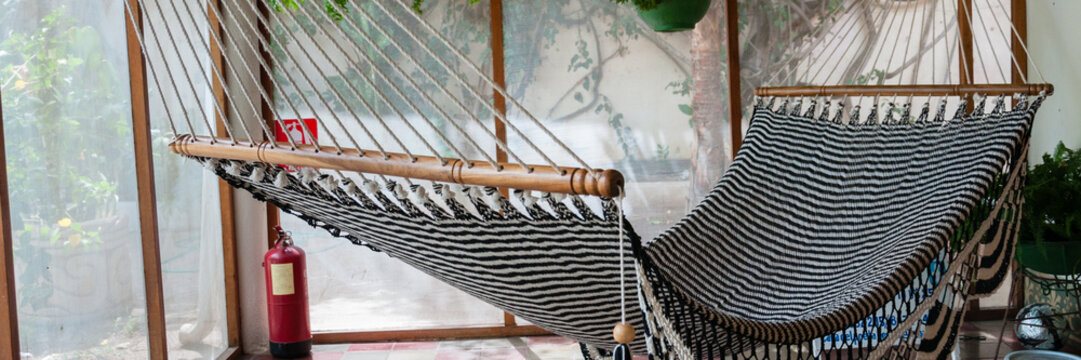 Big huge Hammock in black and white hanging inside a patio