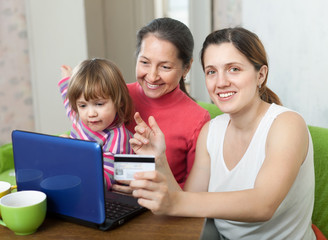 Fototapeta na wymiar Family of three generations shopping online