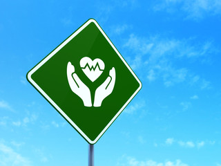 Insurance concept: Heart And Palm on road sign background