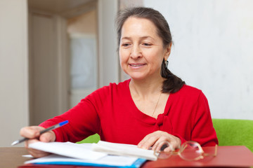 woman reads documents at home