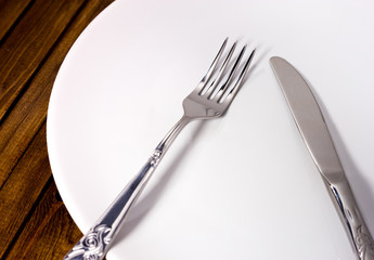 fork and knife with white plate