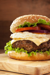 hambuger with pork grilled,egg fried and vegetable on wooden boa