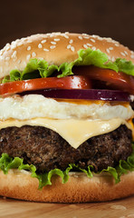hambuger with pork grilled,egg fried and vegetable on wooden boa