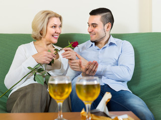 Mature woman with young guy indoors