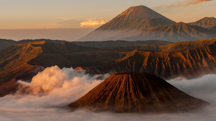 Smoking Volcano Bromo with fog and mist at sunrise in Indonesia