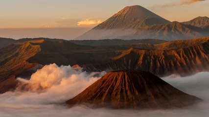 Tuinposter Smoking Volcano Bromo with fog and mist at sunrise in Indonesia © attiarndt