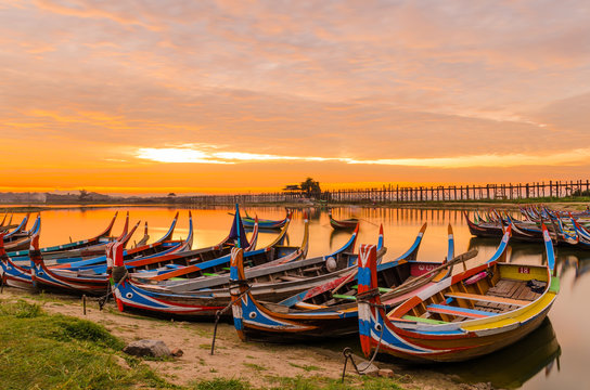 Wooden boat in Ubein Bridge at sunrise, Mandalay, Myanmar (World longest wooden bridge)