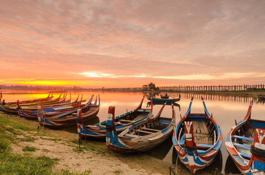 Wooden boat in Ubein Bridge at sunrise, Mandalay, Myanmar (World longest wooden bridge)