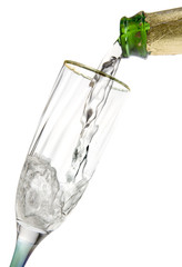Champagne poured from bottle into empty glass on white background. Clipping path incl.
