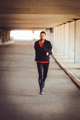 Young man running in an urban environment
