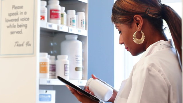 Pharmacy: Woman Using Digital Tablet To Take Inventory