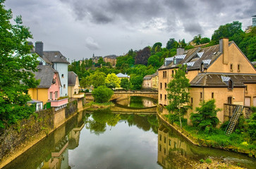Fototapeta na wymiar River with houses and bridges in Luxembourg, Benelux, HDR