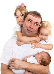 Portrait of a happy father, surrounded by three children.