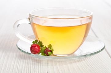 Cup of tea and strawbarries on the white wooden table