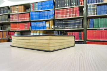 book on desk in library with book column background