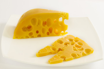 Piece of cheese on white plate
