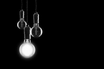Fototapeta na wymiar Idea and leadership concept Vintage incandescent Edison bulbs on