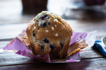 Fresh blueberry muffins served on wooden table