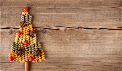 Christmas card with natural decorations on wooden background