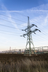 Electricity pylon with dramatic cloudy sky vertical photo