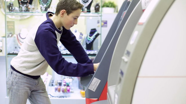 Teenager boy Using Cash Machine