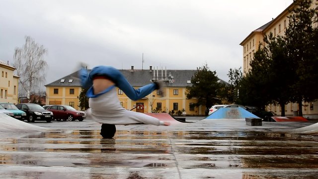 Breakdancer turns his head in the rain