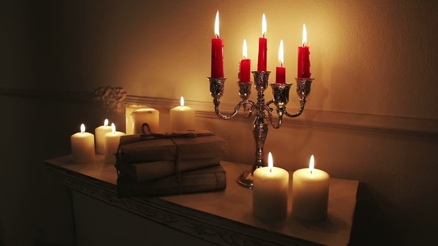 Old vintage books with candles in candlestick.