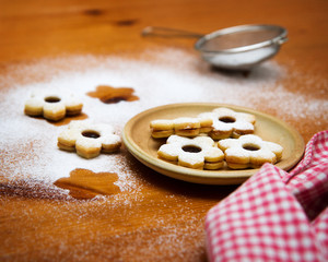 christmas cookies with powdered sugar on wooden table