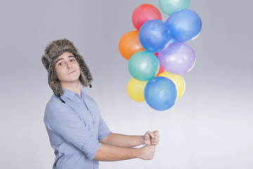Boy holding colorful balloons 