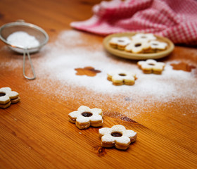 homemade christmas cookies powdered with sugar on wooden table