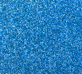 Blue glitter texture close-up as a background.