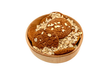 oatmeal and oat cookies in a wooden bowl on a white background