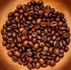 Coffee beans in a wooden bowl. Close up